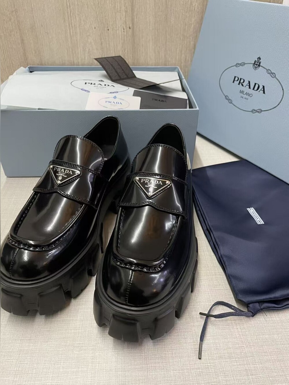 Prada triangular logo black loafers
